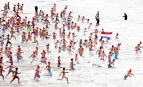 Scheveningen, 2013. január 1. Résztvevők futnak az Északi-tengerbe a scheveningeni hagyományos újévi fürdőzésen